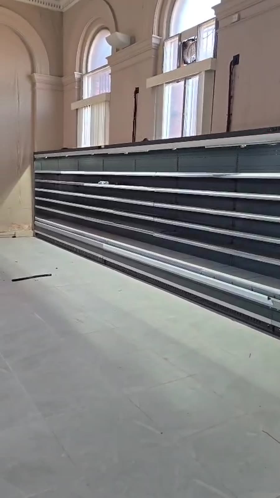 Multideck display chiller run with the shelves and light strips fitted