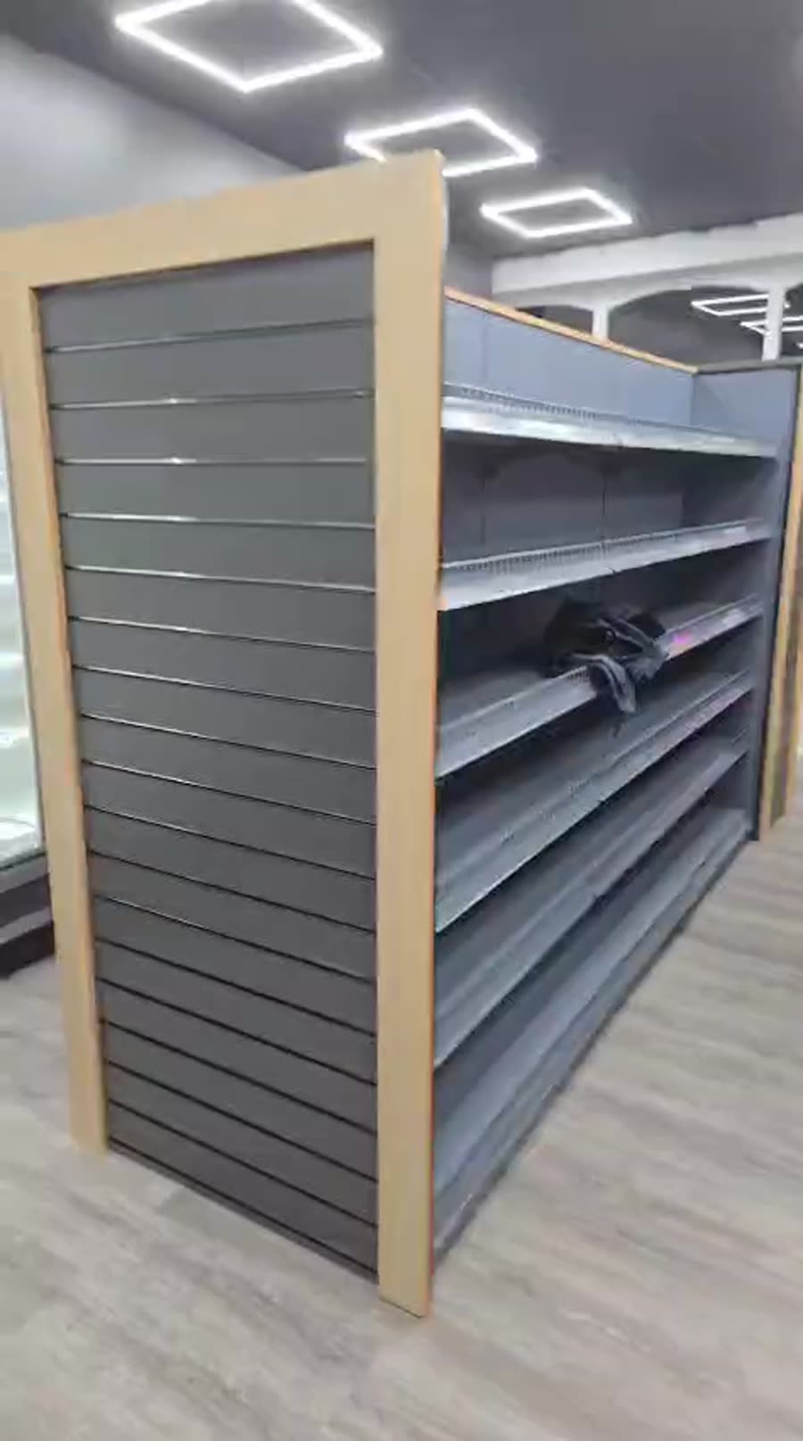 Finished convenience store fit-out with gondola shelving and slatwall end bays