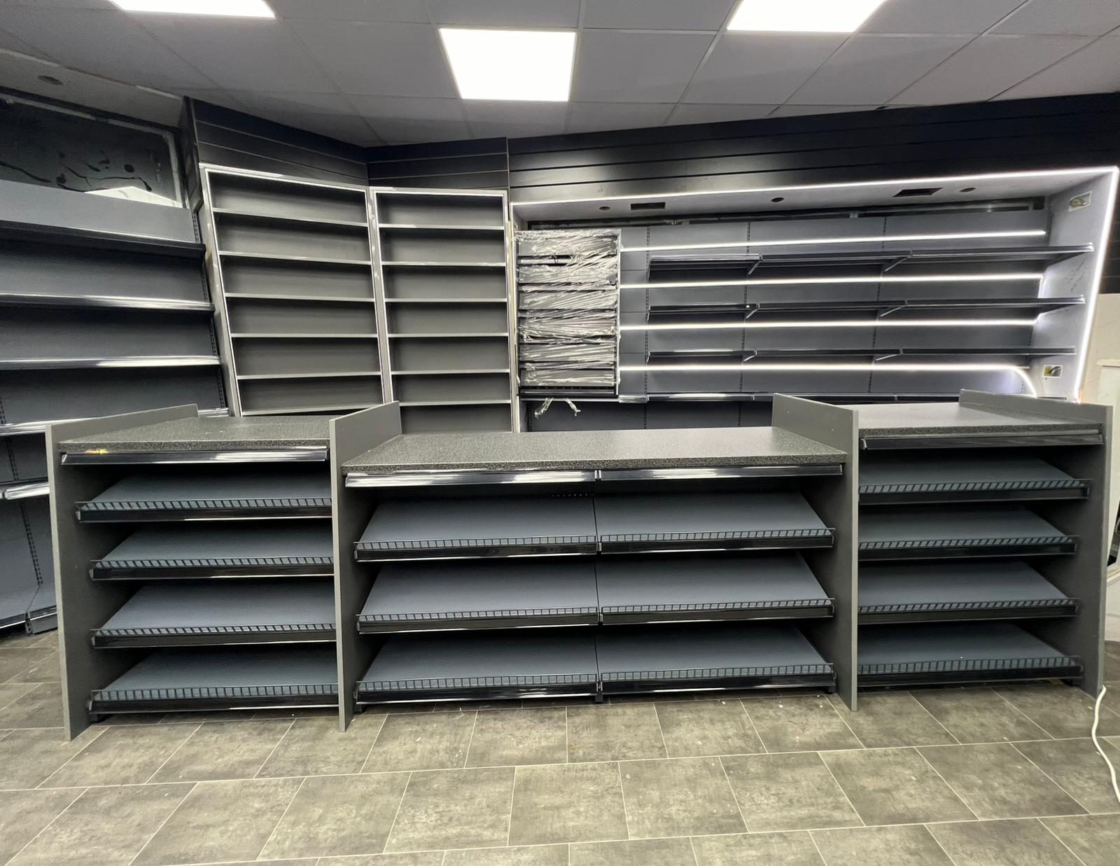 Serve-over counters and gondola bays in a dark-finish store